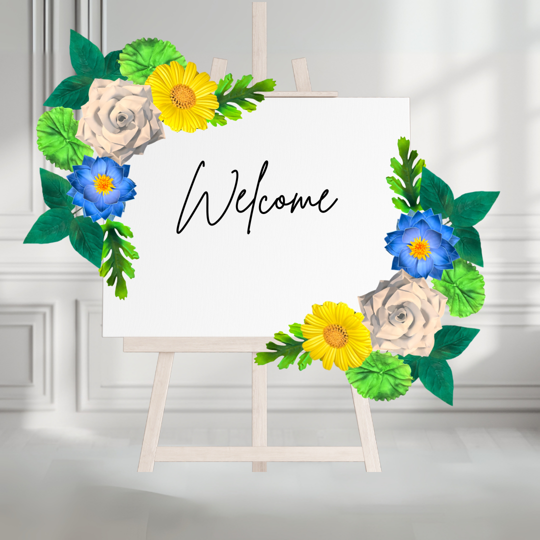 Welcome sign decorated with giant foam wall flowers in warm colors featuring cursive welcome text overlay